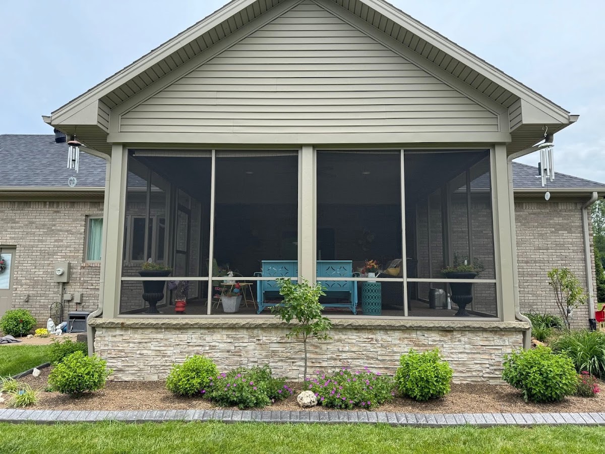 Finished screened porch addition on a brick home