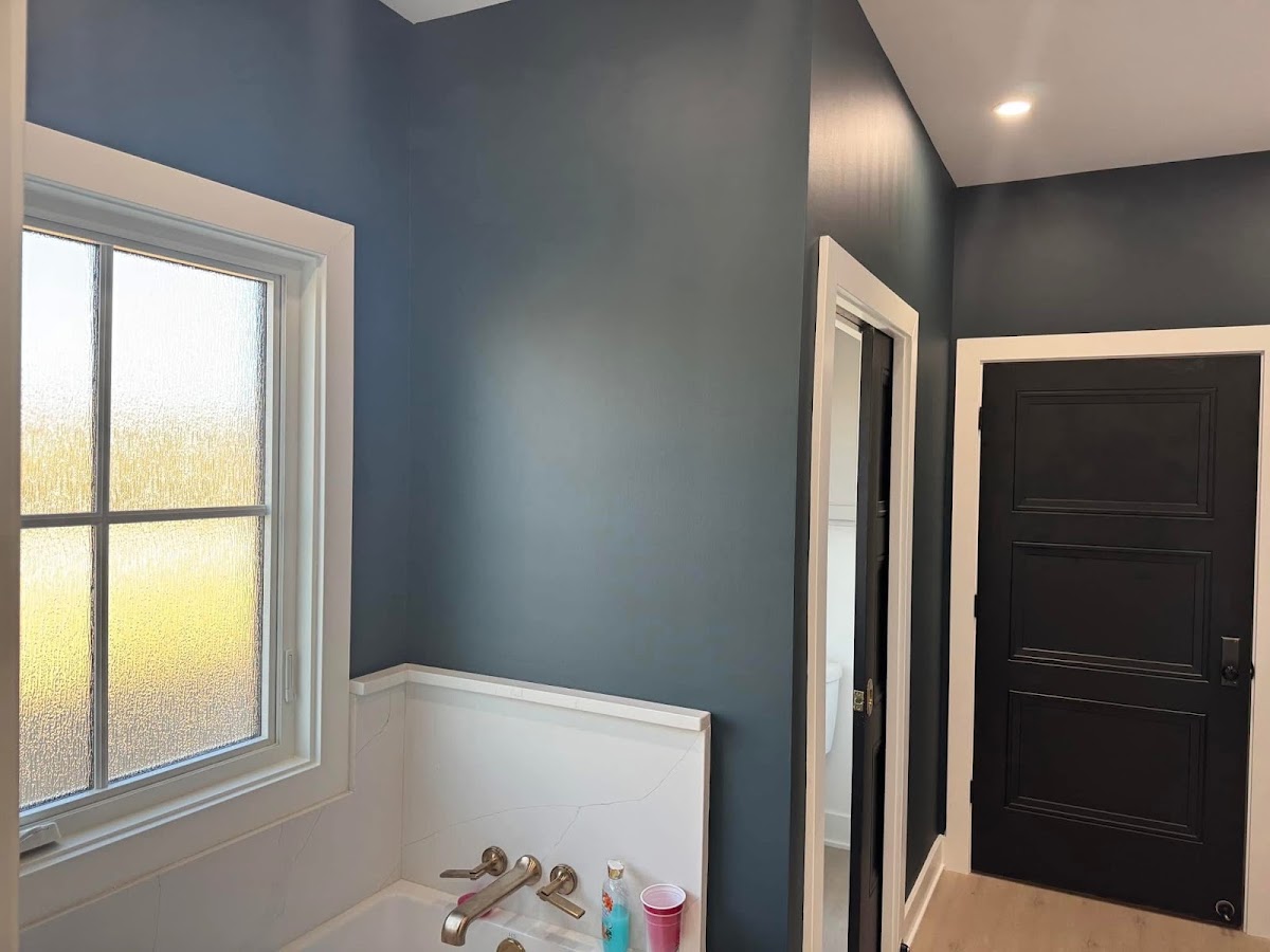 Bathroom with blue painted walls, white trim, and new fixtures