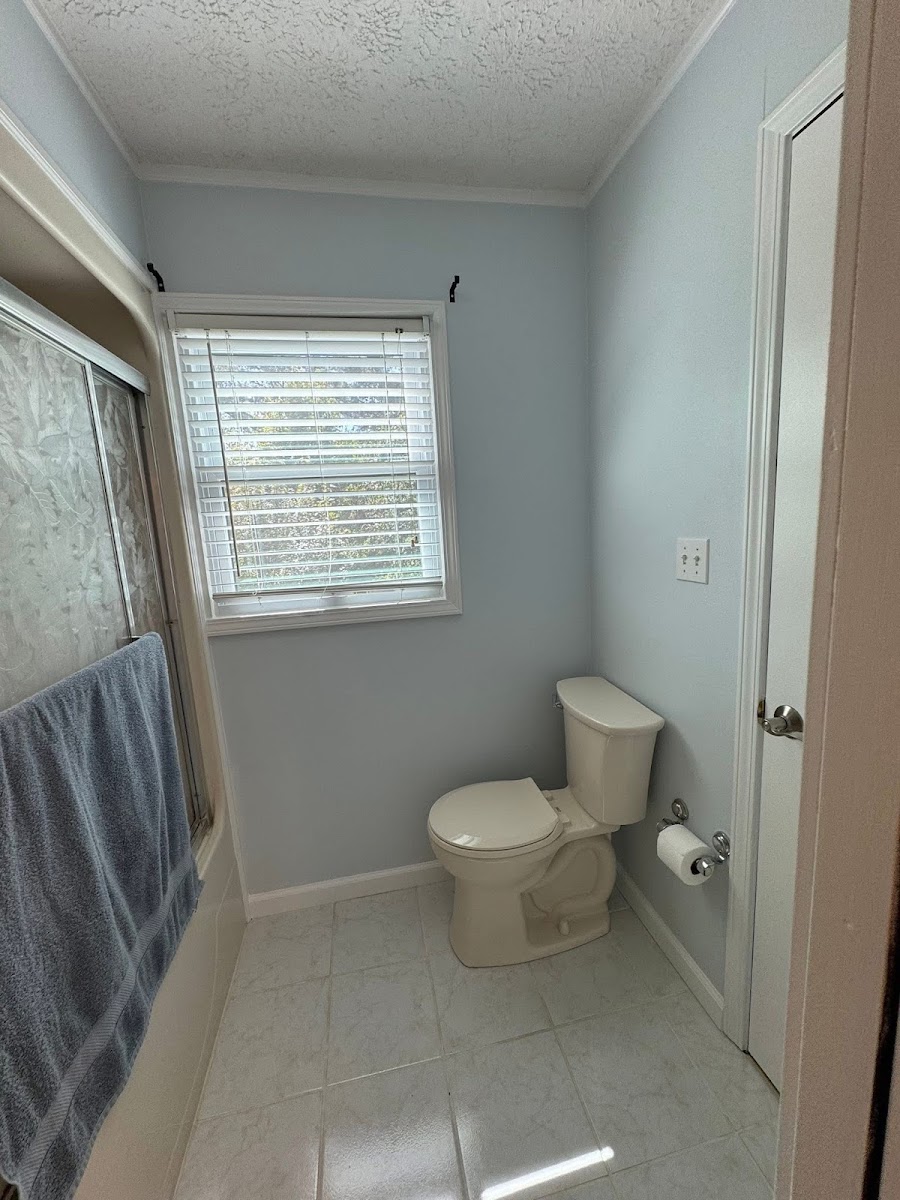 Bathroom with painted walls, tile floor, and shower